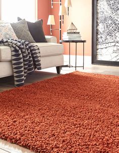 an orange area rug in a living room