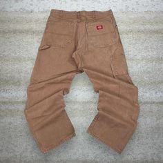 Vintage Dickies Carpenter Pants Camel Tan Canvas Baggy Fit Dungarees Work Wear Painters 90s Skate / Streetwear Great Condition: 9/10 Men's Size:  Waist: 34" Length (inseam): 32" Leg Opening: 9" Thigh Opening: 13" Front Rise: 13" 90s Style Bottoms With Pockets For Fall, Brown Bottoms With Belt Loops For Streetwear, 90s Style Cargo Pants With Pockets For Fall, Casual Brown Work Pants With Belt Loops, Casual Brown Work Pants For Streetwear, Vintage Baggy Bottoms With Pockets, Vintage Beige Bottoms With Pockets, Vintage Brown Bottoms With Cargo Pockets, Retro Relaxed Fit Brown Bottoms