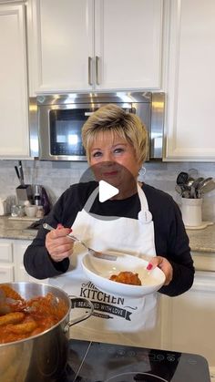 a woman holding a plate of food in front of her face with the words kitchen written on it