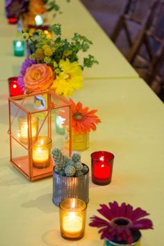 candles and flowers are sitting on the table