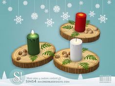 three candles sitting on wooden slices with snowflakes in the background