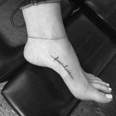 a woman's foot with the word faith tattooed on it