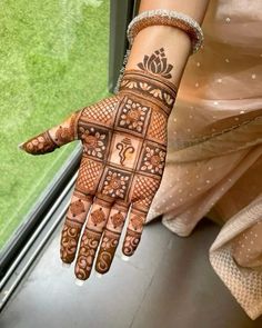 a woman's hand with henna on it