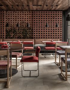 a restaurant with wooden walls and red chairs