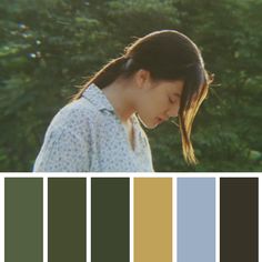 a woman standing in front of trees with her eyes closed and the color swatches below her