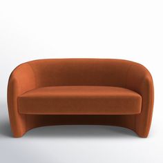 an orange couch sitting on top of a white floor