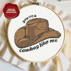 a cross stitch cowboy hat with the words you're a cowboy like me