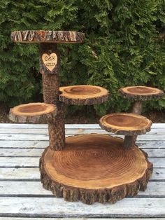 a wooden table topped with three tiered tree stumps