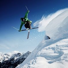 a man flying through the air while riding skis