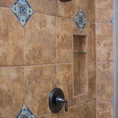 the shower head is mounted on the tile wall