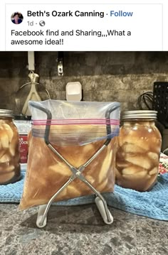 three jars filled with food sitting on top of a counter next to a towel and scissors