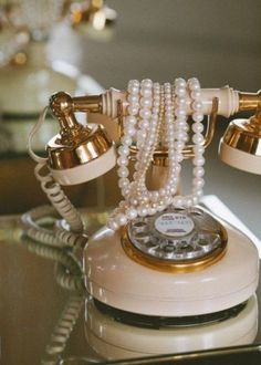 an old fashioned phone with pearls on it