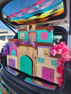 the trunk of a car decorated with colorful decorations