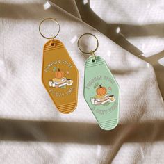 two key chains with pumpkins on them