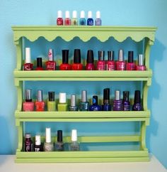 a green shelf filled with lots of nail polish