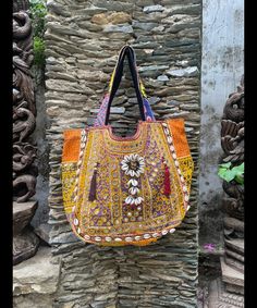 About bag  Indo-gypsy fusion, everyday use hand bag made from Banjara fabrics sourced from Vintage tribal costumes of regions of Rajastan and Gujarat. These are embellished with light catching coins, and intricate bead work tassels. Size - length 15 inches/ width 21 inches Company details:  Company name: Houseoftextile  Contact number: +919784447473  Email id: houseoftextile77@gmail.com  Shipping & custom : Delivery through one of the finest service providers : Skyway, Fedex, UPS  And DHL. Any l Traditional Tote Shoulder Bag With Handwork, Traditional Bags With Mirror Work For Navratri, Traditional Navratri Bags With Mirror Work, Bohemian Tote Bag With Mirror Work, Traditional Rectangular Hobo Bag For Festivals, Traditional Shoulder Bag With Handwork In Tote Shape, Traditional Tote Shoulder Bag For Festivals, Traditional Multicolor Embroidered Hobo Bag For Festivals, Traditional Festival Tote Shoulder Bag