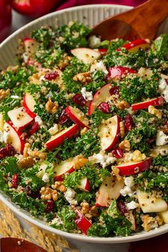 a salad with apples, cheese and nuts in a bowl