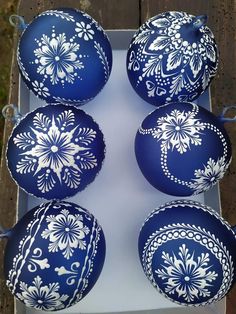 six blue and white ornaments in a box