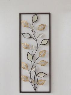 a metal wall hanging with leaves on it