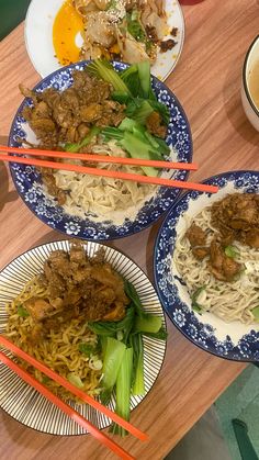 three plates of food on a table with chopsticks