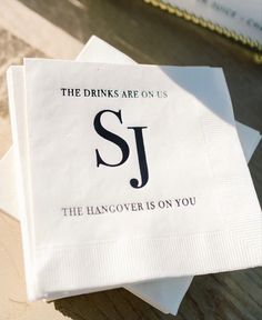 two napkins with the words, the drinks are on us and the hangover is on you