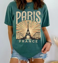 Elevate your wardrobe with this stylish Paris, France tshirt, featuring a chic Eiffel Tower design. Made from soft, high-quality cotton, this shirt is perfect for lovers of Paris and travel enthusiasts. Its timeless design makes it an ideal gift for anyone who appreciates the charm and romance of the City of Lights. Whether you're strolling through your local park or planning your next adventure, this T-shirt will keep you comfortable and fashionable. Available in various sizes and colors, it's Paris Tshirt Designs, Perfect Live, Tower Design, Tour Eiffel, Life Design, Look Plus, Favorite Shirts, Paris France, Comfort Colors