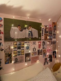 a bedroom with pictures and lights on the wall