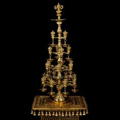 an elaborately decorated gold stand with candles