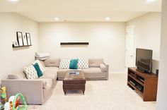 a living room filled with furniture and a flat screen tv