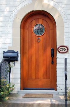 a wooden door is shown in front of a white brick building