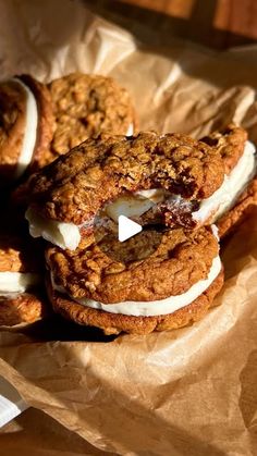 three cookies with marshmallows are on wax paper