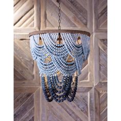 a blue beaded chandelier hanging from a wooden ceiling