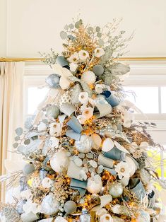 a christmas tree decorated with blue and white ornaments