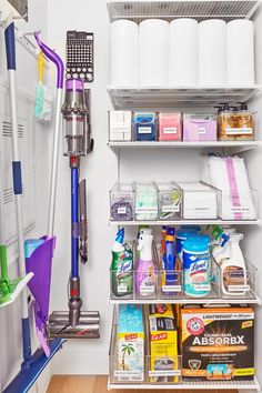 the closet is filled with cleaning supplies and other household care items, including a vacuum cleaner