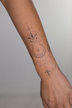 a person's arm with an arrow and stars tattoo on the left side of their arm