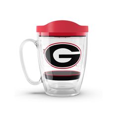 a glass cup with a red lid and the letter g on it