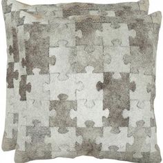 two pillows made out of puzzle pieces on a white background, one is grey and the other is brown