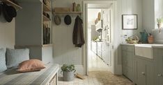 a kitchen filled with lots of counter top space next to a sink and stovetop oven