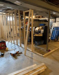 an unfinished room with wood framing and tools on the floor