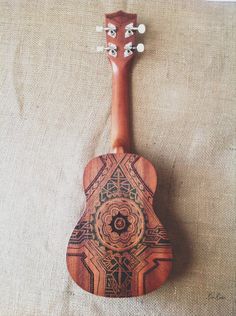 a wooden ukulele sitting on top of a bed