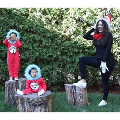 three children dressed up as dr seuss and cat in the hat sitting on stumps