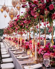 an instagram photo with flowers and candles on the table in front of it is shown