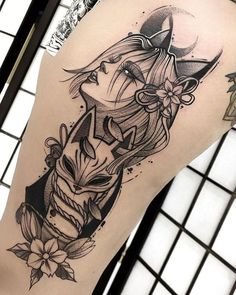 a woman's thigh with an owl and flower tattoo design on her left leg