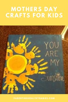 a blue book with yellow handprints and the words you are my sunshine written on it