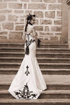 a woman in a dress standing on some steps