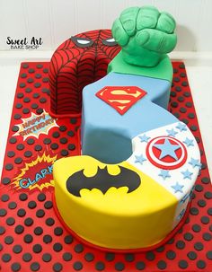 a birthday cake decorated to look like superheros