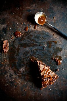 a piece of cake sitting on top of a table next to a cup of tea