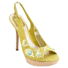 GUARANTEED AUTHENTIC CHRISTIAN DIOR FLORAL PLATFORM SANDALS Design: - Fabulous yellow snakeskin platform sandals. - Floral design crafted in yellow straw and aqua blue beads. - Natural colored straw platform and heel. - Adjustable ankle strap with gold metal dangling logo. - Open toe. - Leather insole and soles. - Comes with designer dust bag. Size: 38 Measurements (Approximate): - Insole, 9.875" - Platform, 1" - Heel Height, 5" To Our Customers: o We consider it a privilege to serve as your lux Chanel Boots, Yellow Sandals, Dior Sandals, Sandal Platform, Designer Sandals, Open Toe Sandals, Ankle Strap Sandals, Platform Sandals, Snake Skin