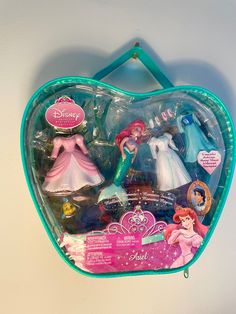 there are two princess dolls in the heart shaped case