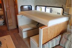 the inside of a camper with bunk beds and couches